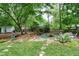 Serene backyard featuring a koi pond, seating areas, and lush landscaping at 5112 Wolcott Ct, Fuquay Varina, NC 27526