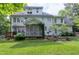 Backyard view featuring a patio, screened-in porch, and lush landscaping at 5112 Wolcott Ct, Fuquay Varina, NC 27526