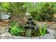 Charming backyard with a tranquil pond, waterfall, and vibrant landscaping at 5112 Wolcott Ct, Fuquay Varina, NC 27526