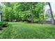 Spacious backyard with mature trees and a green lawn that offers many possibilities at 5112 Wolcott Ct, Fuquay Varina, NC 27526