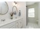 Bright bathroom with double sinks and decorative mirrors at 5112 Wolcott Ct, Fuquay Varina, NC 27526