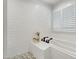 A modern bathtub with a tiled surround is accented by a nearby shuttered window at 5112 Wolcott Ct, Fuquay Varina, NC 27526