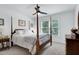 Cozy bedroom with a four-poster bed, matching furniture, and large windows at 5112 Wolcott Ct, Fuquay Varina, NC 27526