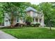 Beautiful home featuring a well-maintained front lawn, brick facade, and a welcoming porch at 5112 Wolcott Ct, Fuquay Varina, NC 27526
