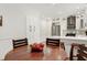 Bright kitchen featuring stainless steel appliances, white cabinets, sleek countertops, and a cozy dining area at 5112 Wolcott Ct, Fuquay Varina, NC 27526