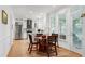 Bright kitchen featuring stainless steel appliances, white cabinetry, light countertops, and a cozy breakfast nook at 5112 Wolcott Ct, Fuquay Varina, NC 27526