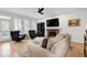 Inviting living room with a brick fireplace, plush seating, and plantation shutters for natural light control at 5112 Wolcott Ct, Fuquay Varina, NC 27526