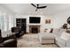 Comfortable living room with a brick fireplace, stylish furnishings, and a ceiling fan for added comfort at 5112 Wolcott Ct, Fuquay Varina, NC 27526