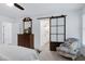 Spacious main bedroom featuring a patterned chair, dresser, and decorative sliding door at 5112 Wolcott Ct, Fuquay Varina, NC 27526