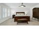 Bright main bedroom with a wooden bed frame, shuttered windows, and a ceiling fan at 5112 Wolcott Ct, Fuquay Varina, NC 27526