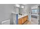Bright bathroom featuring a double sink vanity and a view to the bedroom at 5547 Sea Daisy Dr, Raleigh, NC 27606