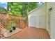 Cozy backyard deck with privacy lattice and a metal table and chairs with direct access to storage at 5547 Sea Daisy Dr, Raleigh, NC 27606