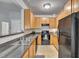 Functional kitchen featuring wood cabinets, black appliances, and laminate countertops at 5547 Sea Daisy Dr, Raleigh, NC 27606