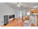 Bright living room with neutral walls, hardwood floors and comfortable seating area open to kitchen at 5547 Sea Daisy Dr, Raleigh, NC 27606
