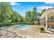 Community pool and clubhouse surrounded by mature trees and landscaping at 5547 Sea Daisy Dr, Raleigh, NC 27606