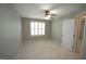 Comfortable bedroom with a ceiling fan, neutral carpet, and bright windows at 5927 Hourglass Ct, Raleigh, NC 27612