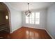 Elegant dining room featuring hardwood floors, gray walls, and a modern orb chandelier at 5927 Hourglass Ct, Raleigh, NC 27612