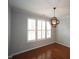 Modern dining room showcases hardwood floors, crown molding, shutters, and an orb chandelier at 5927 Hourglass Ct, Raleigh, NC 27612