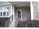 Inviting front porch with stone accents, manicured shrubs, and a stylish entrance at 5927 Hourglass Ct, Raleigh, NC 27612