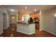 Well-equipped kitchen featuring hardwood floors, granite countertops, and stainless steel appliances at 5927 Hourglass Ct, Raleigh, NC 27612