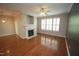 Inviting living room with hardwood floors, fireplace, and access to a sliding glass door at 5927 Hourglass Ct, Raleigh, NC 27612