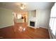 Open-concept living room with hardwood floors, fireplace, and view into the adjacent kitchen at 5927 Hourglass Ct, Raleigh, NC 27612