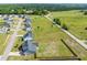 Aerial view showcasing a home with a fenced backyard, surrounded by green spaces and other residences at 60 Heart Pine Dr, Wendell, NC 27591