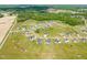 Wide aerial shot of a residential area with homes surrounded by lush greenery and a peaceful landscape at 60 Heart Pine Dr, Wendell, NC 27591