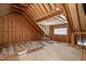 Spacious unfinished attic with wooden beams and window, offering customization for various purposes at 60 Heart Pine Dr, Wendell, NC 27591
