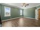 Bright bedroom featuring two windows, wood floors, and neutral decor at 60 Heart Pine Dr, Wendell, NC 27591