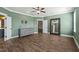 Spacious bedroom featuring a ceiling fan, wood floors, and a large mirror at 60 Heart Pine Dr, Wendell, NC 27591