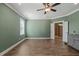 Bedroom with wood floors, a ceiling fan, and an ensuite bathroom at 60 Heart Pine Dr, Wendell, NC 27591