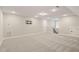 Well-lit bonus room with carpet, neutral walls, TV mount, and access to stairs at 60 Heart Pine Dr, Wendell, NC 27591