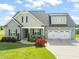 Beautiful exterior view of a two-story home featuring a well-manicured lawn and a two-car garage at 60 Heart Pine Dr, Wendell, NC 27591