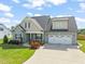 Attractive exterior of a two-story home with manicured landscaping, a two-car garage, and a charming entrance at 60 Heart Pine Dr, Wendell, NC 27591