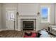 Beautiful fireplace featuring stone surround, white mantle, and decorative lanterns at 60 Heart Pine Dr, Wendell, NC 27591
