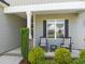 Charming front porch featuring rocking chairs and lush landscaping, perfect for relaxing outdoors at 60 Heart Pine Dr, Wendell, NC 27591