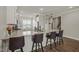 Kitchen with white cabinets, granite countertops, breakfast bar with seating, and modern finishes at 60 Heart Pine Dr, Wendell, NC 27591