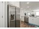 Spacious kitchen with stainless steel refrigerator and granite countertops overlooking the living area at 60 Heart Pine Dr, Wendell, NC 27591