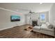 Bright living room with a modern fireplace, large TV, and comfortable sectional sofa at 60 Heart Pine Dr, Wendell, NC 27591