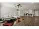 Open-concept living room with kitchen access, modern lighting, and hardwood floors at 60 Heart Pine Dr, Wendell, NC 27591