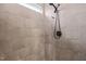 Close-up of shower with tiled wall, shower head, and window at 60 Heart Pine Dr, Wendell, NC 27591