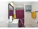 Bathroom features a vanity sink, large framed mirror, and shower with colorful curtain at 607 E Granville St, Dunn, NC 28334