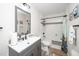 Bathroom featuring modern vanity, framed mirror, and tub with subway tile surround and shower at 607 E Granville St, Dunn, NC 28334