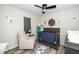 Bedroom with crib, accent wall art, chair, and wood-look flooring at 607 E Granville St, Dunn, NC 28334