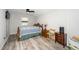 Bedroom features wood-look floors, a bed with a quilt, nightstands and a window at 607 E Granville St, Dunn, NC 28334