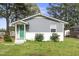 Charming single story home with grey siding, a white brick foundation, and a bright green front door at 607 E Granville St, Dunn, NC 28334