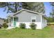 Charming single story home with grey siding, a white brick foundation, and a bright green front door at 607 E Granville St, Dunn, NC 28334