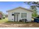 Exterior view of a one-story house with white siding and a gray door at 607 E Granville St, Dunn, NC 28334