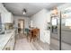 Bright kitchen featuring white cabinets, granite countertops, stainless steel appliances, and wood-look floors at 607 E Granville St, Dunn, NC 28334